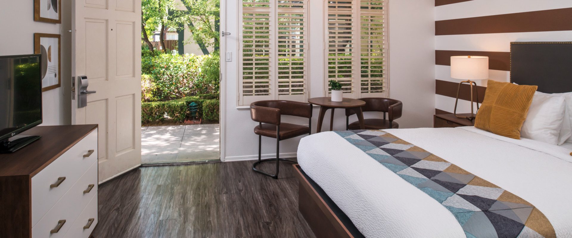 Bedroom with one bed and open patio door